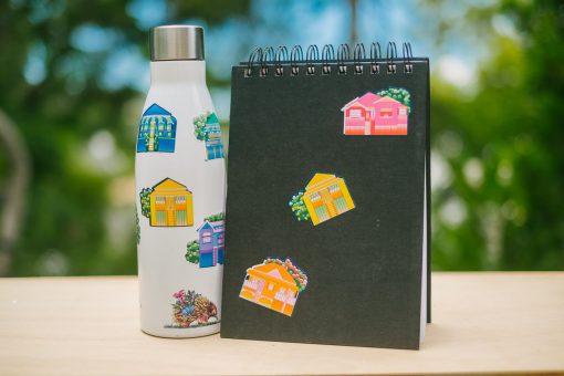 Queensland House Stickers on a Waterbottle and Notepad